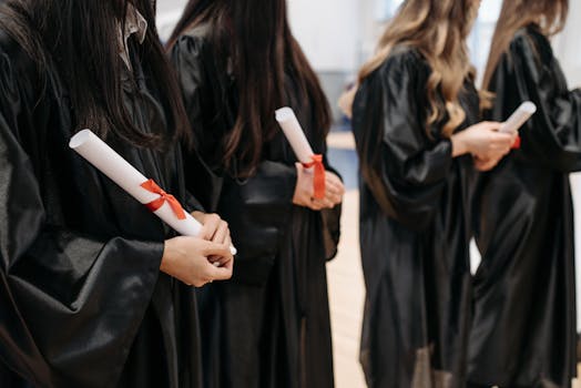 Graduates lined up in gowns holding diplomas at a ceremony. Capturing the essence of academic achievement.